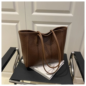Close-up of brown woven texture tote bag on a modern chair for a lifestyle detail shot