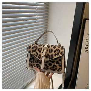 Detail of leopard print small square bag with pony hair texture and gold metal buckle