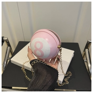 Detail of pink sphere chain bag with billiard number 8 print and gold metal strap