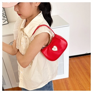 Kids red heart crescent shoulder bag with golden bow detail on child model