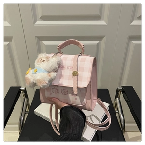 Detail of pink plaid mini backpack with cartoon bear print and plush dog charm