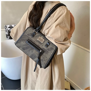 Detail of vintage canvas underarm bag with leather trim worn on shoulder over-the-shoulder