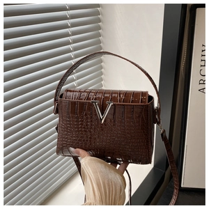 Detailed view of deep brown croc-embossed leather texture and silver V-shaped buckle