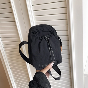 Black lightweight nylon crossbody bag with drawstring pocket and orange fashion label