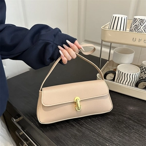 Beige faux leather shoulder bag with gold metal buckle and elegant top handle strap