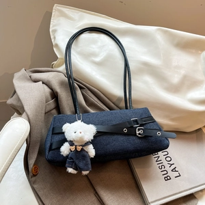 Denim underarm bag with black leather straps and cute plush bear charm decoration