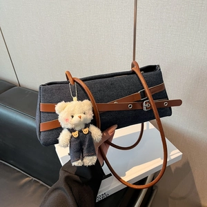 Retro rectangle denim underarm bag with brown leather straps and a plush bear charm