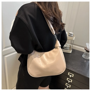 Detail view of a beige minimalist hobo bag showing soft PU leather and elegant draping