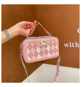 Pink checkered square handbag with rectangular metal buckle and wide woven shoulder strap