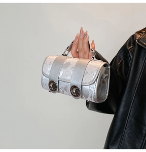 Detail of silver textured mini square bag with metallic finish and vintage metal turn-lock