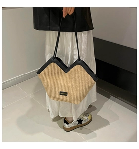 Detail of beige corduroy tote bag featuring a V-neck opening and black leather straps
