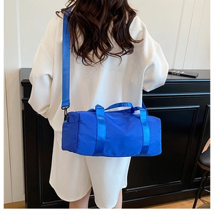 Detail of royal blue cylindrical sports bag in high-quality nylon with adjustable straps
