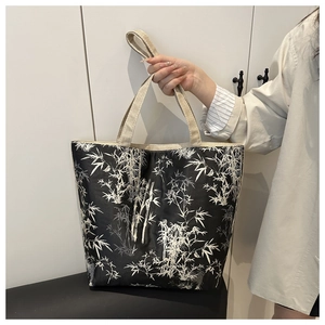 Close-up of large Chinese style tote bag with white bamboo prints on black fabric