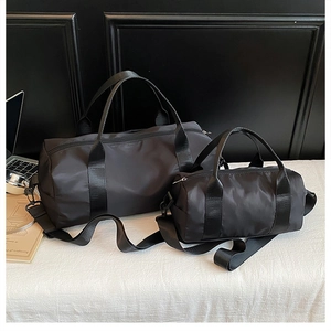 Detailed set of black cylindrical gym bags in large and small sizes with nylon straps