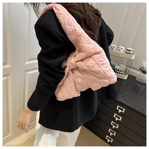 Detail of pink quilted puffer tote bag showing large diamond stitch and padded texture