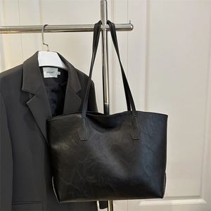Chic black tote bag with vintage wrinkled leather texture and slim shoulder straps