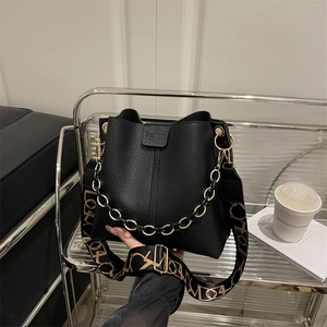 Chic black litchi pattern bucket bag with golden chain and stylish wide strap for women