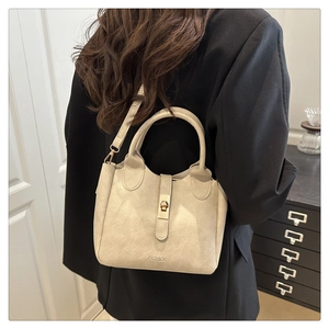 Detailed back view of a beige matte PU leather tote bag with a golden metal buckle