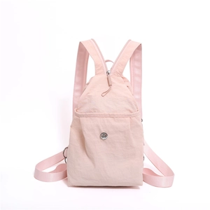 Pink waterproof nylon backpack for women with metal logo and front zipper pocket