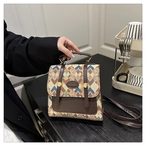 Detail of British style vintage backpack with colorful geometric jacquard and brown leather