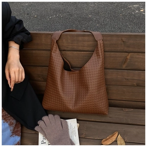 Close-up of the woven PU leather texture on the brown tote bag for women