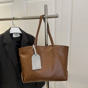 Brown large capacity leather tote bag for women with minimalist commuter shoulder strap