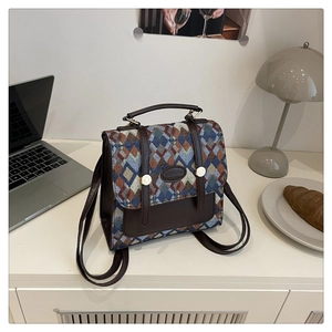 Detail of retro geometric woven canvas backpack with brown leather flap and metal clasp
