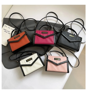 Detail view of woven leather mini square bags in five colors with branding label