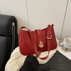 Minimalist red leather shoulder bag featuring unique gold gourd buckle design in 2025 style