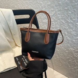 Minimalist black pebble leather tote bag with brown handles and gold Fashion logo