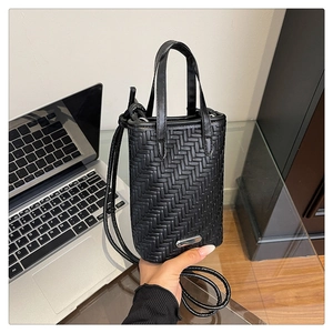 Macro view of matte black woven texture on a versatile crossbody square phone bag