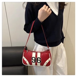 Close-up of red PU leather racing style bag with white stripes and 96 number patch