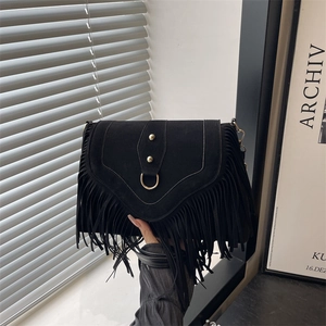 Vintage black faux suede saddle bag with fringe tassel and gold ring hardware details