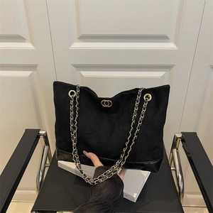 Black quilted suede tote bag with chain strap and gold hardware detail for women