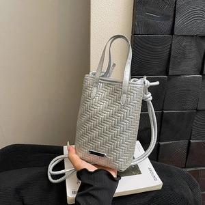 Minimalist silver woven crossbody bag with dual handles and metal logo detail