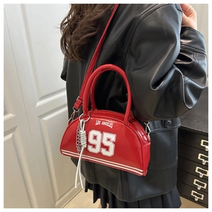 Detail of red leather crossbody bag featuring white Los Angeles print and silver chain