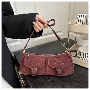 Detail of burgundy leopard print baguette bag featuring dual front pockets and silver chain strap