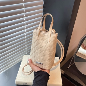 Chic woven cream mini bag with dual handles and slim crossbody strap in a modern style