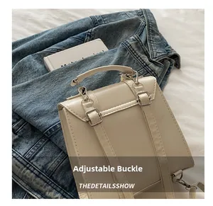 Detail of adjustable silver buckles on cream PU leather backpack with sleek metal hardware