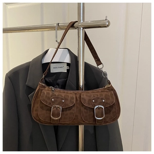Close-up of leopard print suede baguette bag with double pockets and metal buckles