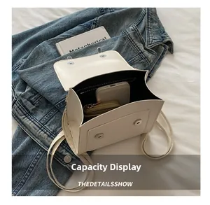 Top view of cream leather backpack showing interior capacity for phone and wallet