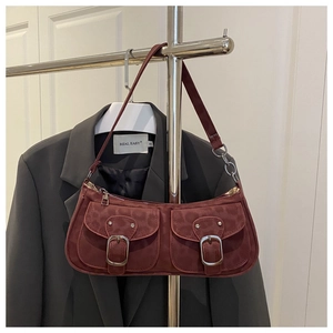 Detail of burgundy faux suede baguette bag with leopard pattern and double pockets