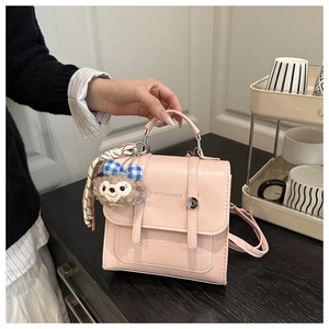 Detail of pink PU leather handbag with metal handle and ShellieMay plush charm