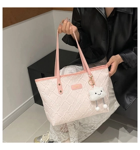 Pink quilted tote bag with white cloud plush charm and textured diamond pattern