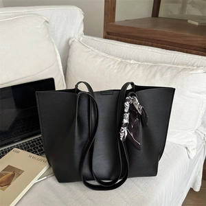 Large black tote bag with silk scarf accessory for commute and travel, professional style