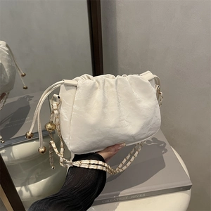 White pleated cloud shoulder bag with gold chain strap and spherical metal accents