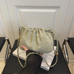 Minimalist light green pleated shoulder bag with gold chain and spherical metal pendant