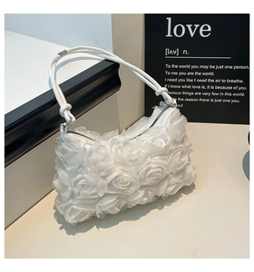 Macro shot of 3D mesh rose flower details on white elegant mesh shoulder bag