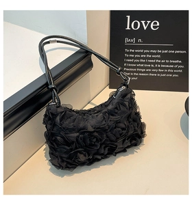 Close-up of 3D rose petal texture on black lace shoulder bag with silver ball detail