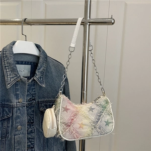 Rainbow patchwork canvas crossbody bag with star pattern and fringe detail on display